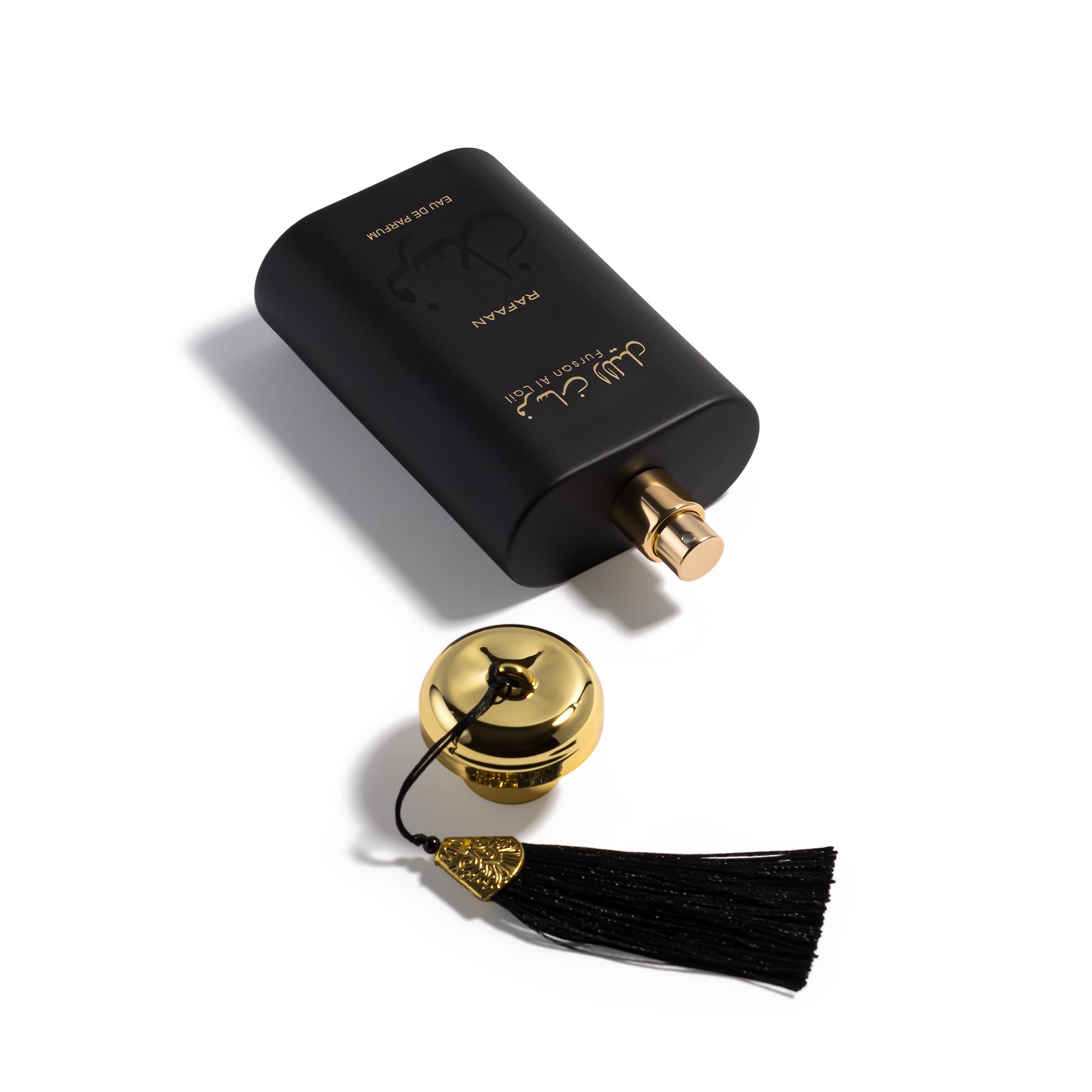 fursan al lail perfume with tassel on a white background