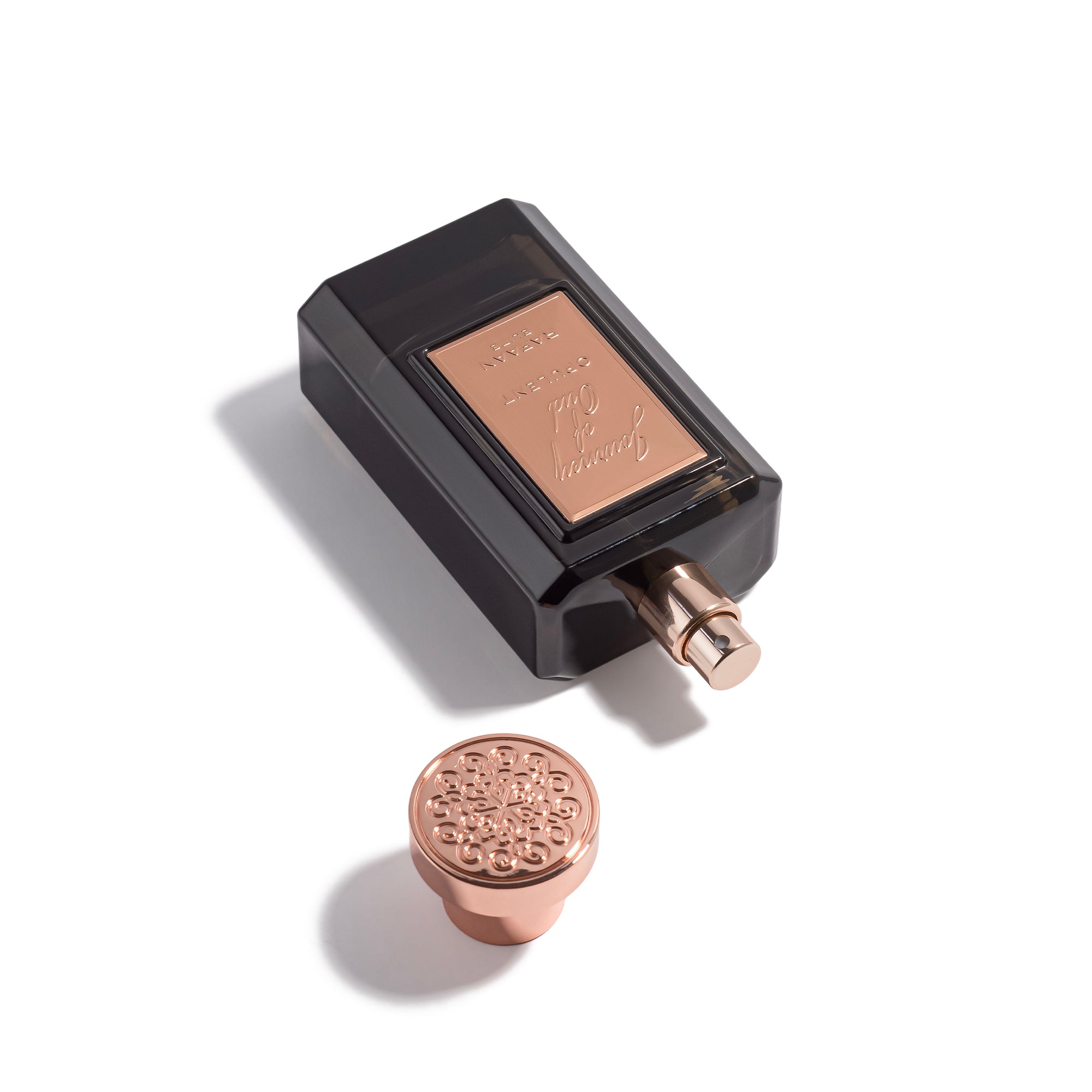 journey of oud opulent perfume bottle with decorative cap on a white background