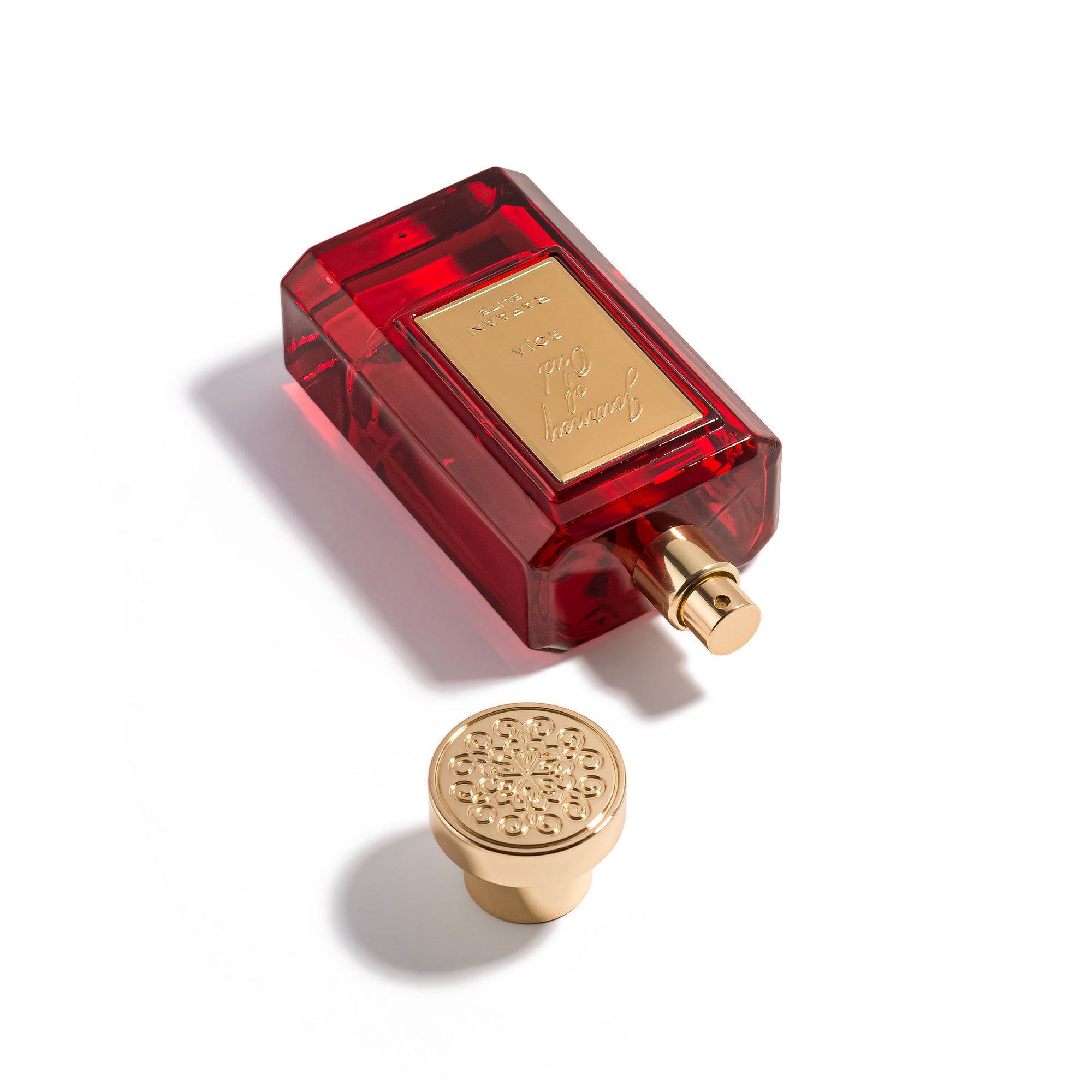 journey of oud roja perfume bottle with gold cap on a white background