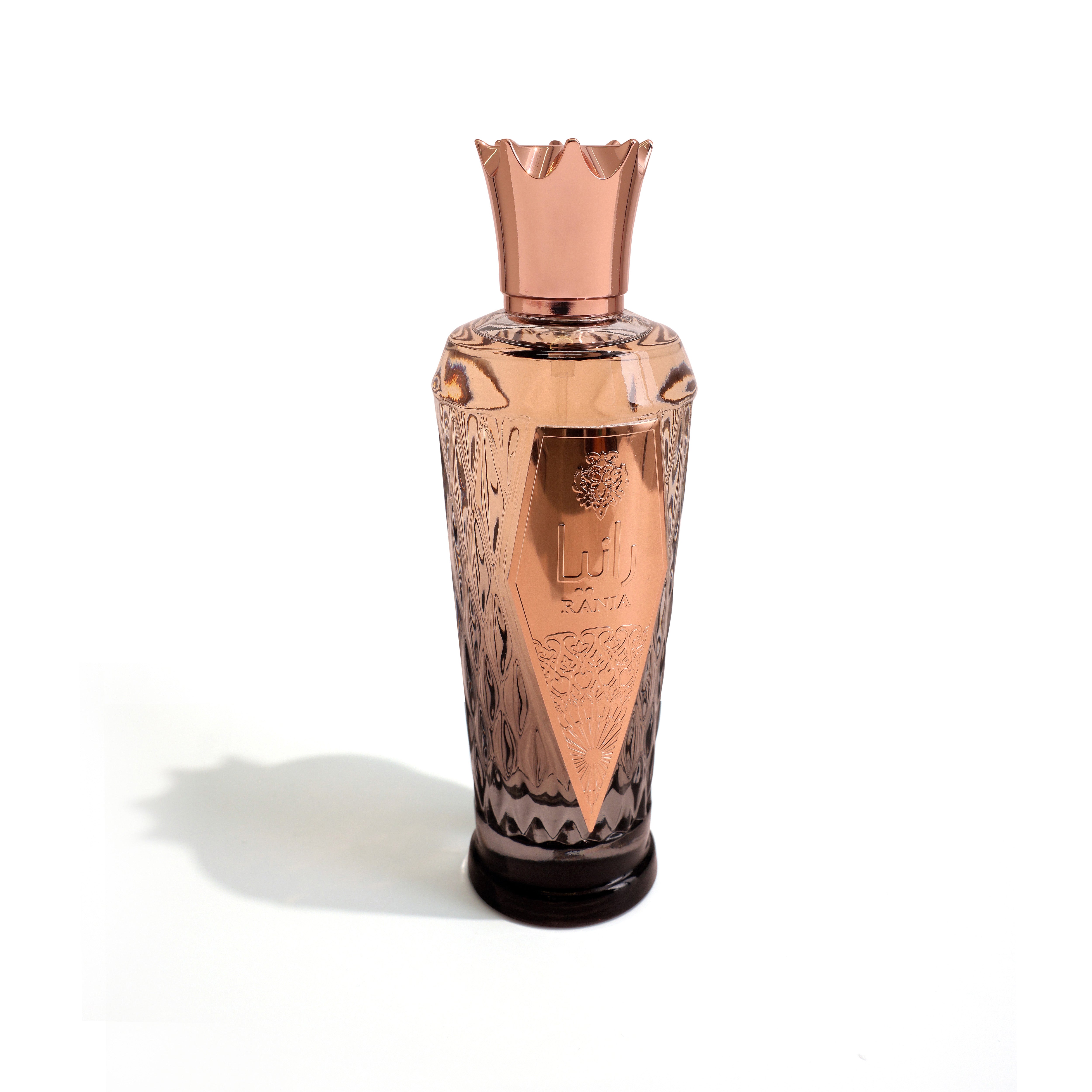 Rose gold and black perfume bottle on a white background