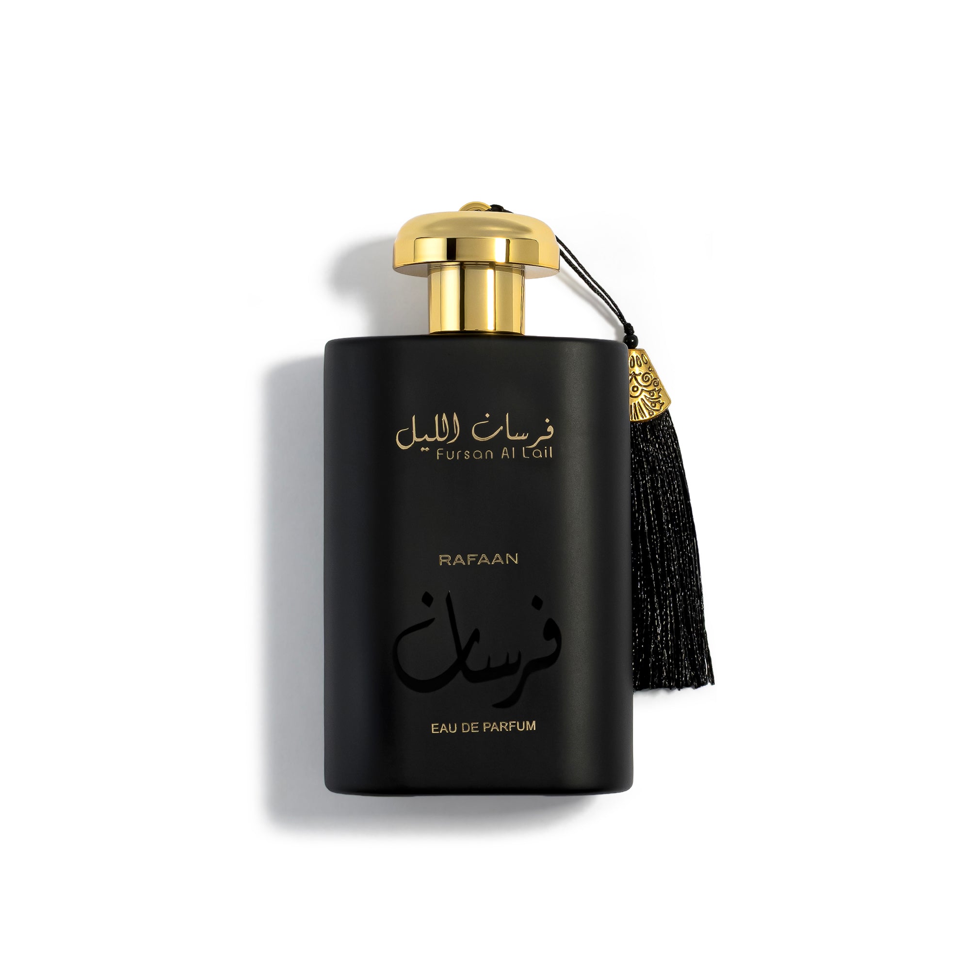 fursan al lail perfume bottle with gold cap and tassel on a white background