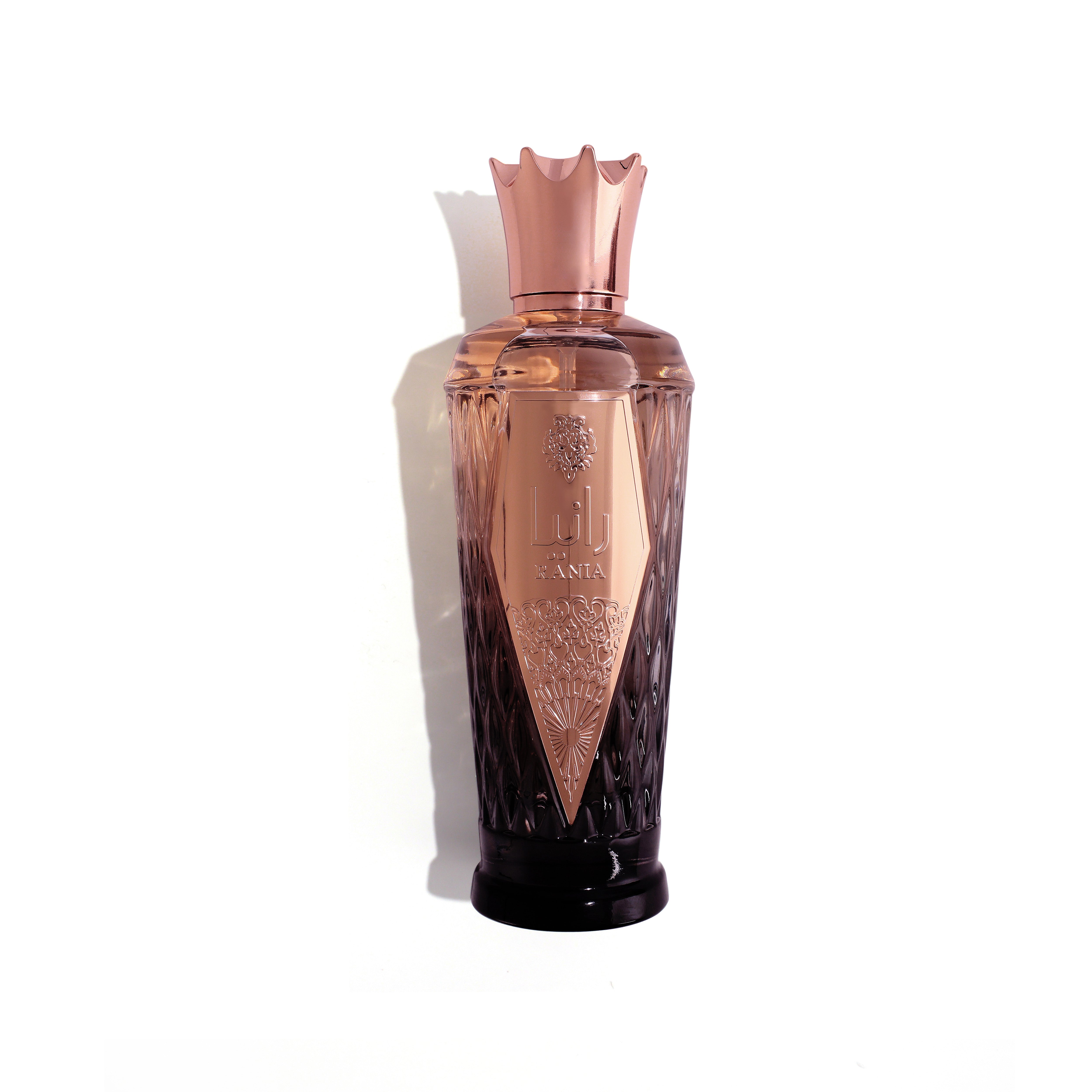 Copper and black perfume bottle on a white background